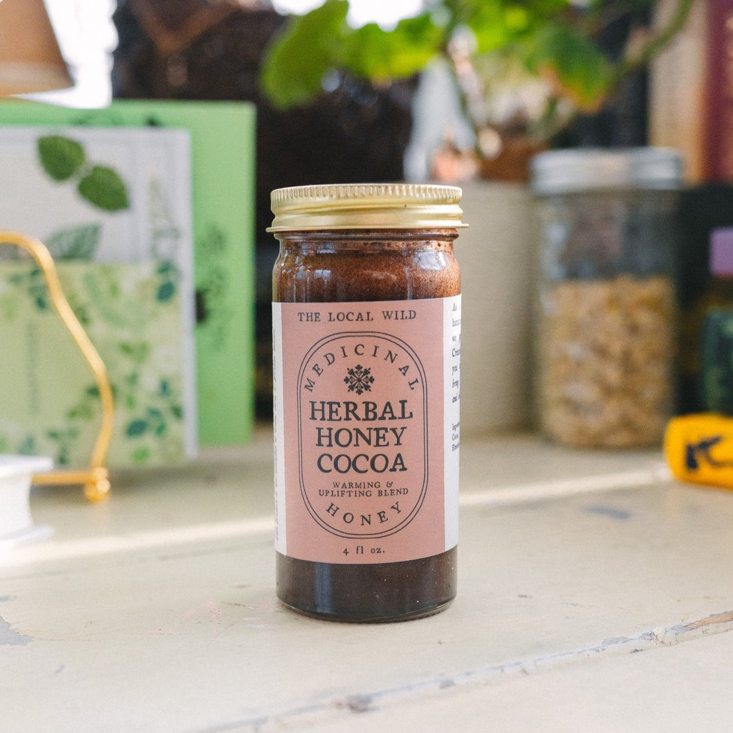 jar of herbal honey cocoa on a white table
