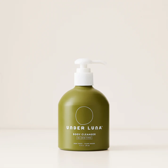 a body cleanser packaged in a green aluminum bottle