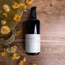 Helios on a wooden background with calendula and a bronze tray 