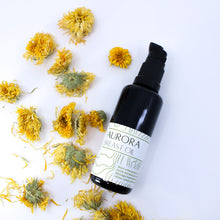 Flatlay with Aurora Breast Oil surrounded by Calendula flowers