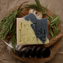 bar of soap with cedar boughs and a feather