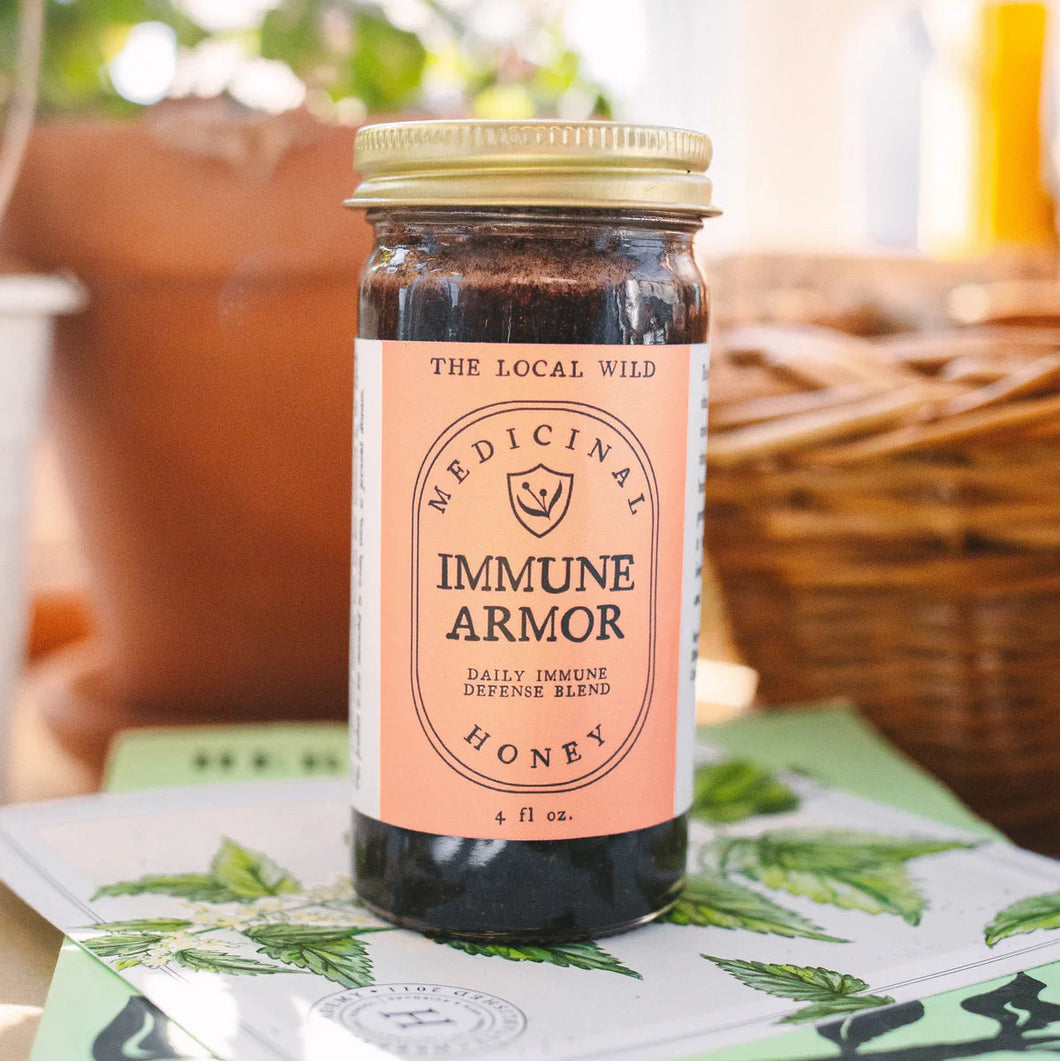 Jar of 'Immune Armor' honey on a table with a natural background