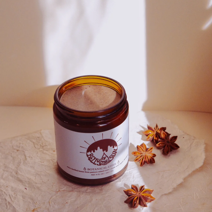 jar of botanical ghee on a neutral background