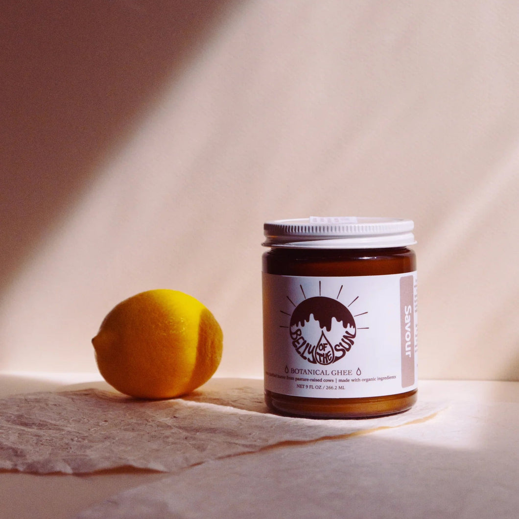 jar of ghee with a lemon next to it