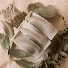 three bars of brown and green soap